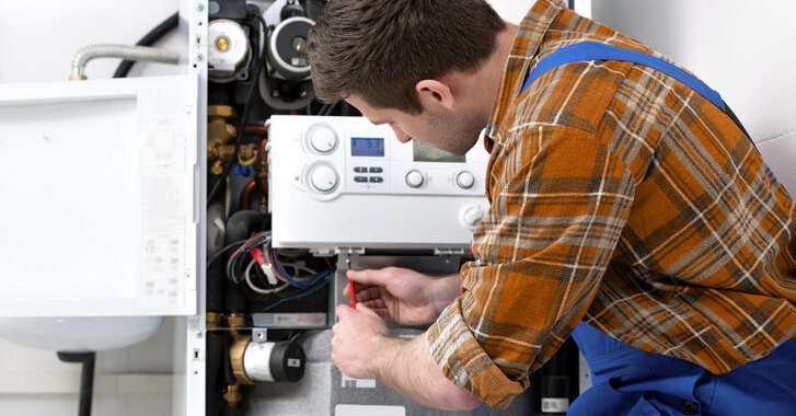 Gas safe plumber repairing installing boiler