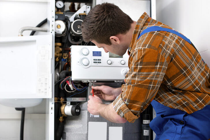 Gas safe plumber repairing installing boiler
