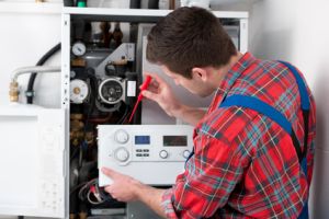 Register heat engineer plumber repairing boiler