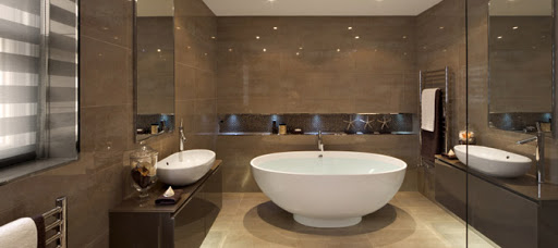 Completed bathroom installed in large room with tiled floors and floor