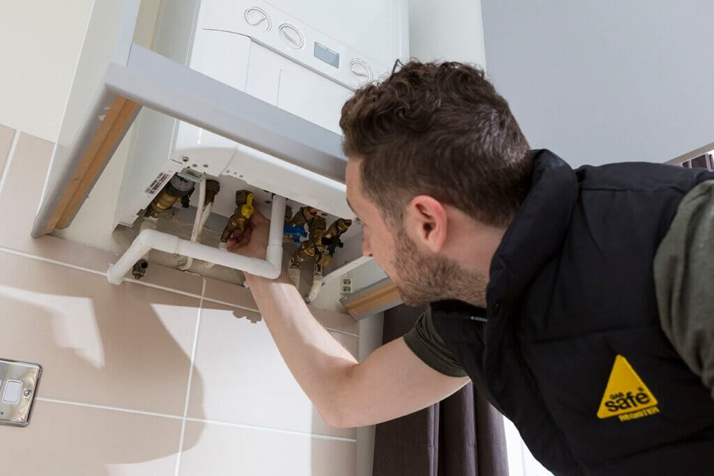 Gas Safe Engineer installing new boiler